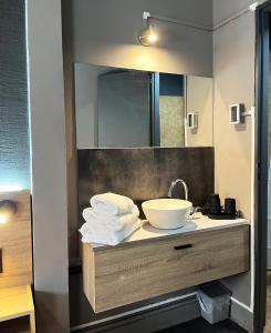 a bathroom with a sink and a mirror and towels at Defensa 821 - Studios in San Telmo in Buenos Aires +62 photos