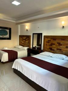 Postel nebo postele na pokoji v ubytování Hotel Framfor Inn Chetumal