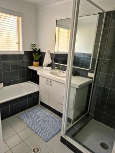 a bathroom with a sink and a shower at Beachfront Bliss in Lennox Head