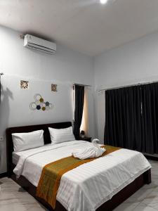 Ένα ή περισσότερα κρεβάτια σε δωμάτιο στο Isyana's hostel Batur