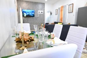 a dining room with a glass table and white chairs at Joyces Highview in Kingstown