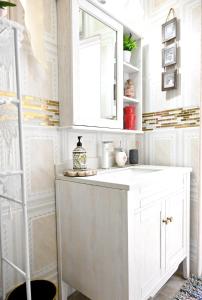 a bathroom with a white sink and a mirror at Joyces Highview in Kingstown