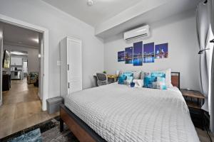 a bedroom with a large bed with blue pillows at Newly renovated luxury 3BR Condo! 30 mins to NYC in Bergen