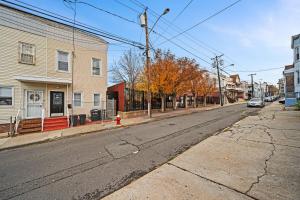 an empty street in a town with a red fire hydrant at Newly renovated luxury 3BR Condo! 30 mins to NYC in Bergen