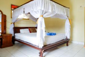 Ένα ή περισσότερα κρεβάτια σε δωμάτιο στο Hotel Segara Kedisan Kintamani