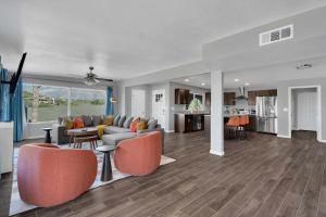an open living room with a couch and chairs at New Sonoran Oasis pool hot Tub Sleeps 12 in Tucson