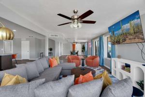 a living room with a couch and a ceiling fan at New Sonoran Oasis pool hot Tub Sleeps 12 in Tucson