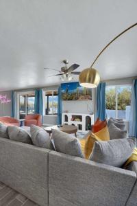 a living room with a large couch with pillows at New Sonoran Oasis pool hot Tub Sleeps 12 in Tucson +31 photos