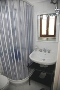 a bathroom with a sink and a shower curtain at Trentinara Cilento in Trentinara