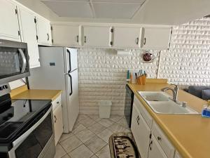 a kitchen with white cabinets and a sink at 439 Ala Wai, 119 condo in Lake Valley