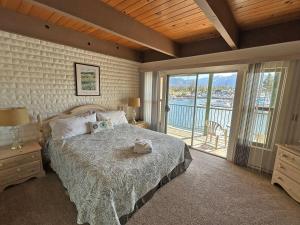 a bedroom with a bed and a view of the water at 439 Ala Wai, 119 condo in Lake Valley +3 photos