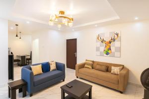 a living room with two couches and a table at Easyinn Shortlet Apartment in Port Harcourt