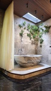 a large wooden tub sitting on a table in a bathroom at Little Town Villa in Hoi An