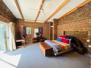 a brick walled bedroom with a bed and a table at Biba's Rooms in Smithfield