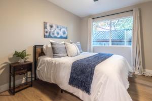 a bedroom with a bed with pillows and a window at Folsom Old Town Escape in Folsom