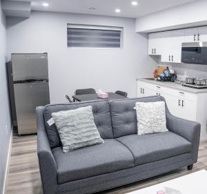 a living room with a couch and a kitchen at Beautiful Brand New 2BR Suite with Private Entrance and free on-site parking in Winnipeg