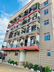 a tall apartment building with plants on the balconies at Kampala Studio with Lake Breeze in Kampala