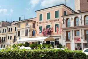 a building with flags in front of it at Hotel Al Castello in Bassano del Grappa