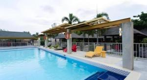 a large swimming pool with chairs and a pavilion at Venue 88 in Dulongabong