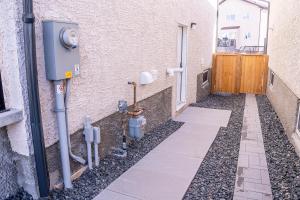 a walkway with a building with a door and some meters at Beautiful Brand New 2BR Suite with Private Entrance and free on-site parking in Winnipeg +15 photos