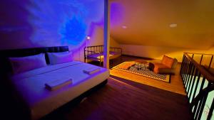 a bedroom with a bed and a chair in a room at Postel Chinatown in Bangkok