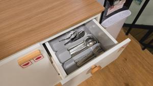 a white box with utensils in it at Postel Chinatown in Bangkok