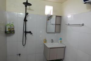 a white bathroom with a shower and a sink at Sen Sapa Retreat & Tours in Sa Pa +37 photos