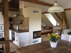 a kitchen and living room with a table in a room at Holiday home Hůrka in Hurka