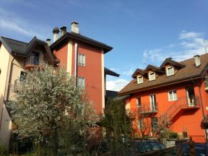 a large orange building with a black roof at Albergo alla Posta B&B in Roana