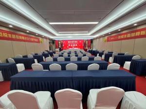 a large room with blue tables and white chairs at James Joyce Coffetel Xuzhou Feng County Huadi Street in Feng