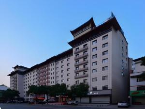 a large building on the side of a street at City Comfort Inn Shiyan Wudang Mountain in Danjiangkou