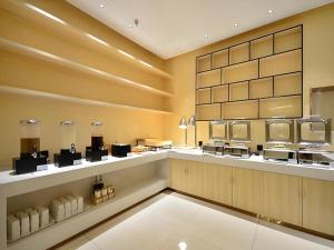 a restaurant kitchen with aasteryasteryasteryasteryasteryasteryasteryasteryasteryasteryastery at City Comfort Inn Shiyan Wudang Mountain in Danjiangkou