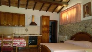 a kitchen with a bed and a table in a room at Agriturismo Il Gelso in Pomaia