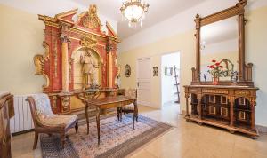 a room with a desk and a table and a mirror at Habitaciones Villa Marcia Solo Adulto in Altafulla