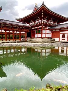 a building with a pond in front of it at Ichiban an in Uji +28 photos