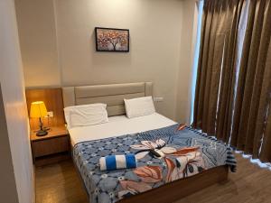 a bedroom with a bed and a picture on the wall at Omaxe stay in Greater Noida