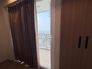 a room with a window with a view of a balcony at Omaxe stay in Greater Noida