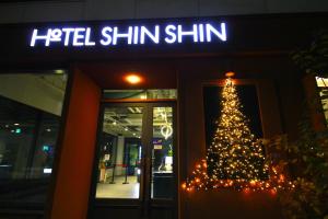Un árbol de Navidad frente a un hotel de la clínica Shimlin. en Seoul Hotel ShinShin Myeongdong, en Seúl