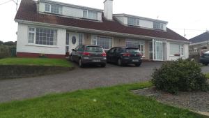 two cars parked in front of a house at Oceanview B&B in Ringville +12 photos