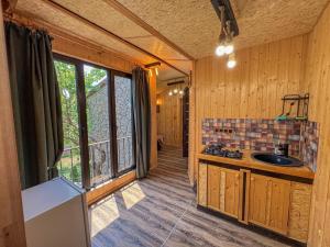 a kitchen with a sink in a wooden house at ErGarden in Byureghavan