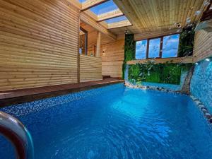 a swimming pool in a house with a wooden wall at ErGarden in Byureghavan