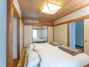 Ένα ή περισσότερα κρεβάτια σε δωμάτιο στο 鶴羽リゾート