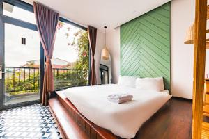 Postel nebo postele na pokoji v ubytování Beyoung Hotel Dalat + 27 fotografií