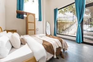 Postel nebo postele na pokoji v ubytování Beyoung Hotel Dalat