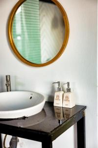 a bathroom with a sink and a mirror at Beyoung Hotel Dalat in Da Lat