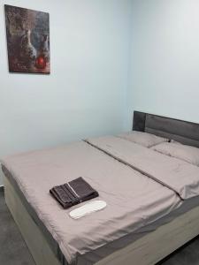 a bed with a wooden frame and a plate on it at Sani Hotel Yerevan in Yerevan