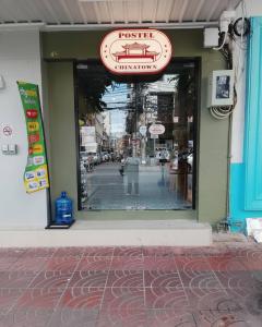 a window of a store with a sign on it at Postel Chinatown in Bangkok
