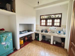 a kitchen with two counters and a window in a room at Nimsara Lodge in Hikkaduwa +2 photos