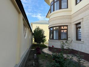 a side view of a house with a yard at B&B Apartment Farhad Hospitality Solutions in Samarkand +9 photos