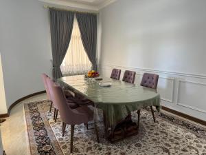 a dining room with a table and chairs at B&B Apartment Farhad Hospitality Solutions in Samarkand +9 photos